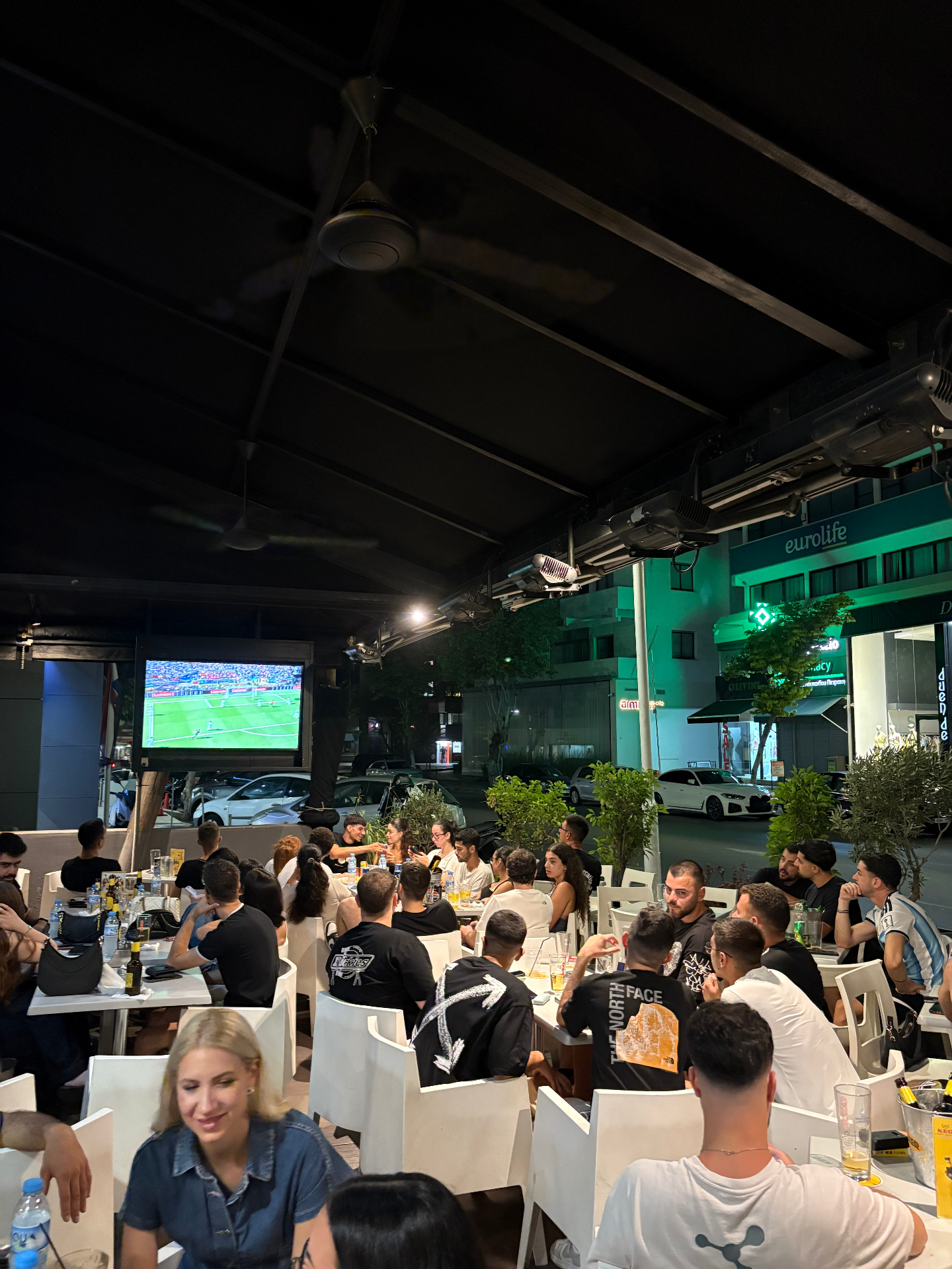 Terrace crowd watching football